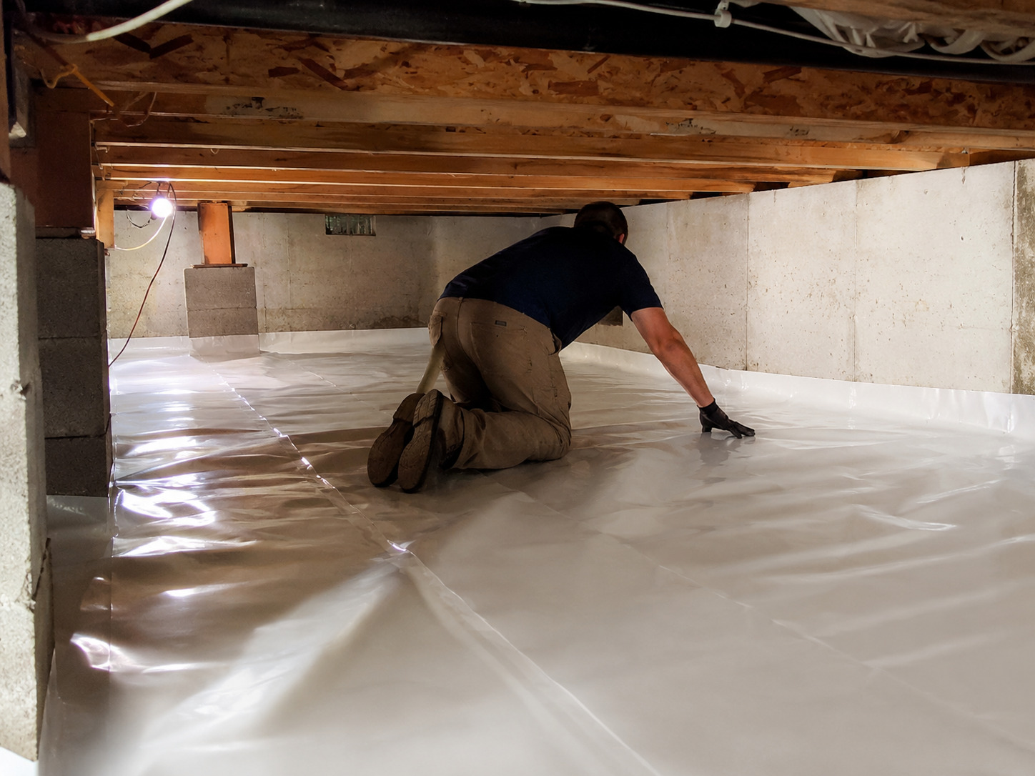 Vapor barrier installed across a Rochester crawl space after mold removal