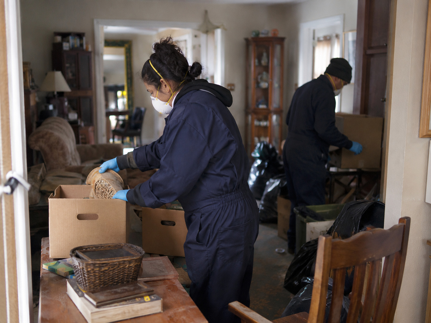 Professional hoarding cleanup crew sorting and organizing