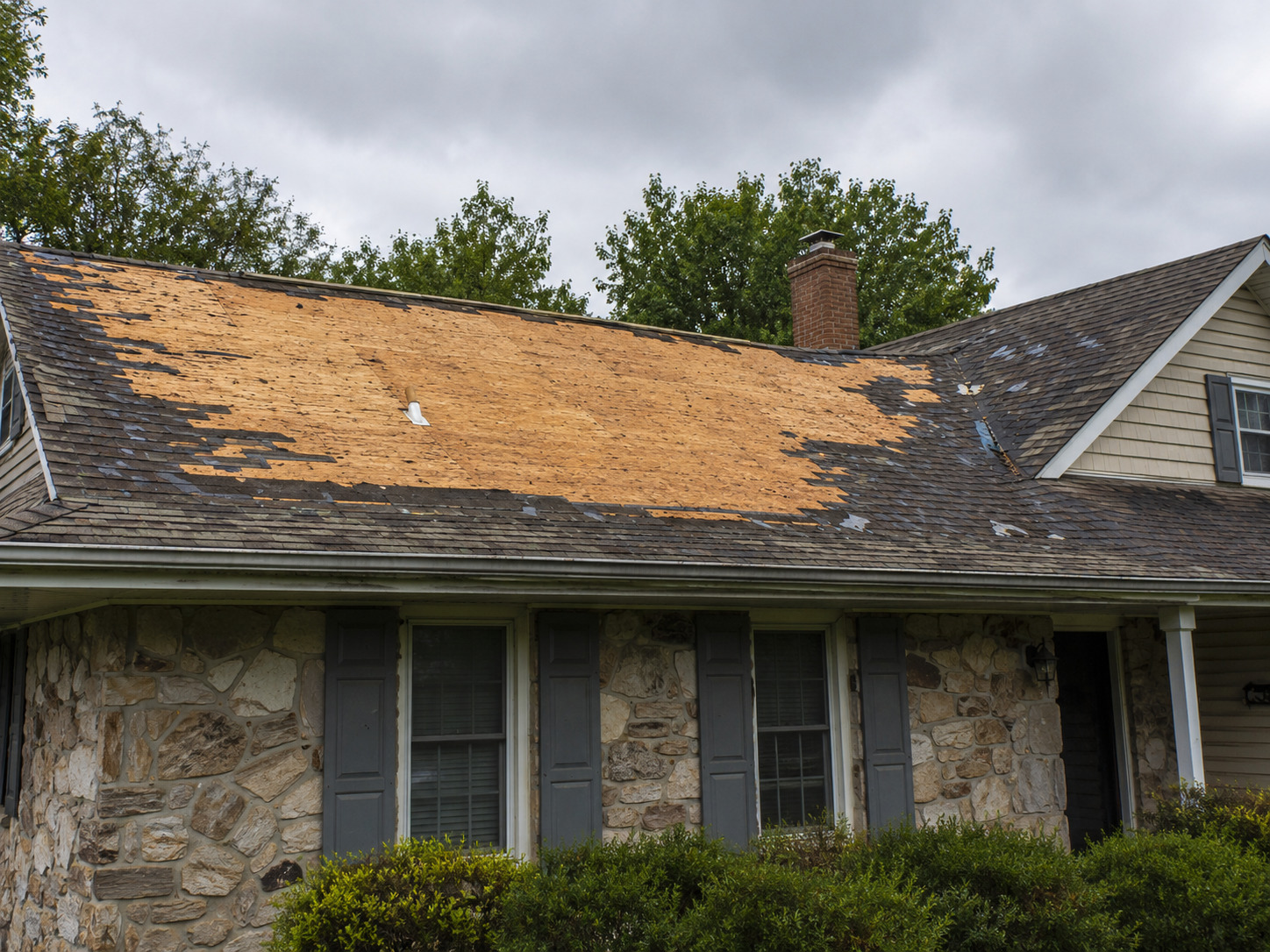Storm damaged roof before wrap