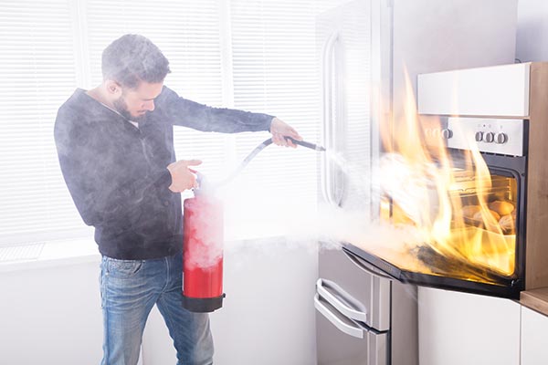 man-with-fire-extinguisher putting out a fire