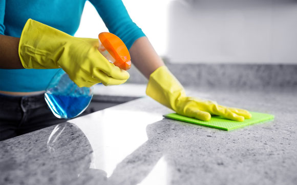 Mold Cleaner being used by female with yellow gloves