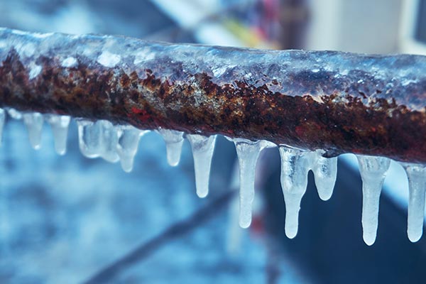 Burst pipes with icicles causing winter water damage